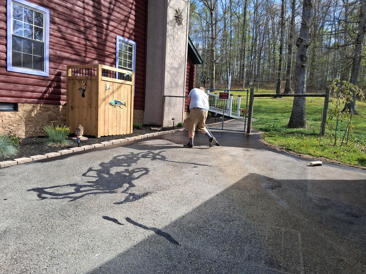 Driveway sealing in progress in greater beckley area wv asphalt driveway being sealed in fairdale wv
