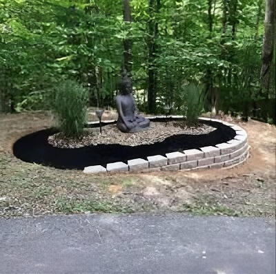 Zen garden Glen Daniel, WV Glen Daniel garden bed installation with mulch, river stone, hardscaping pavestone retaining wall, with accent ornamental grasses with buddha statue